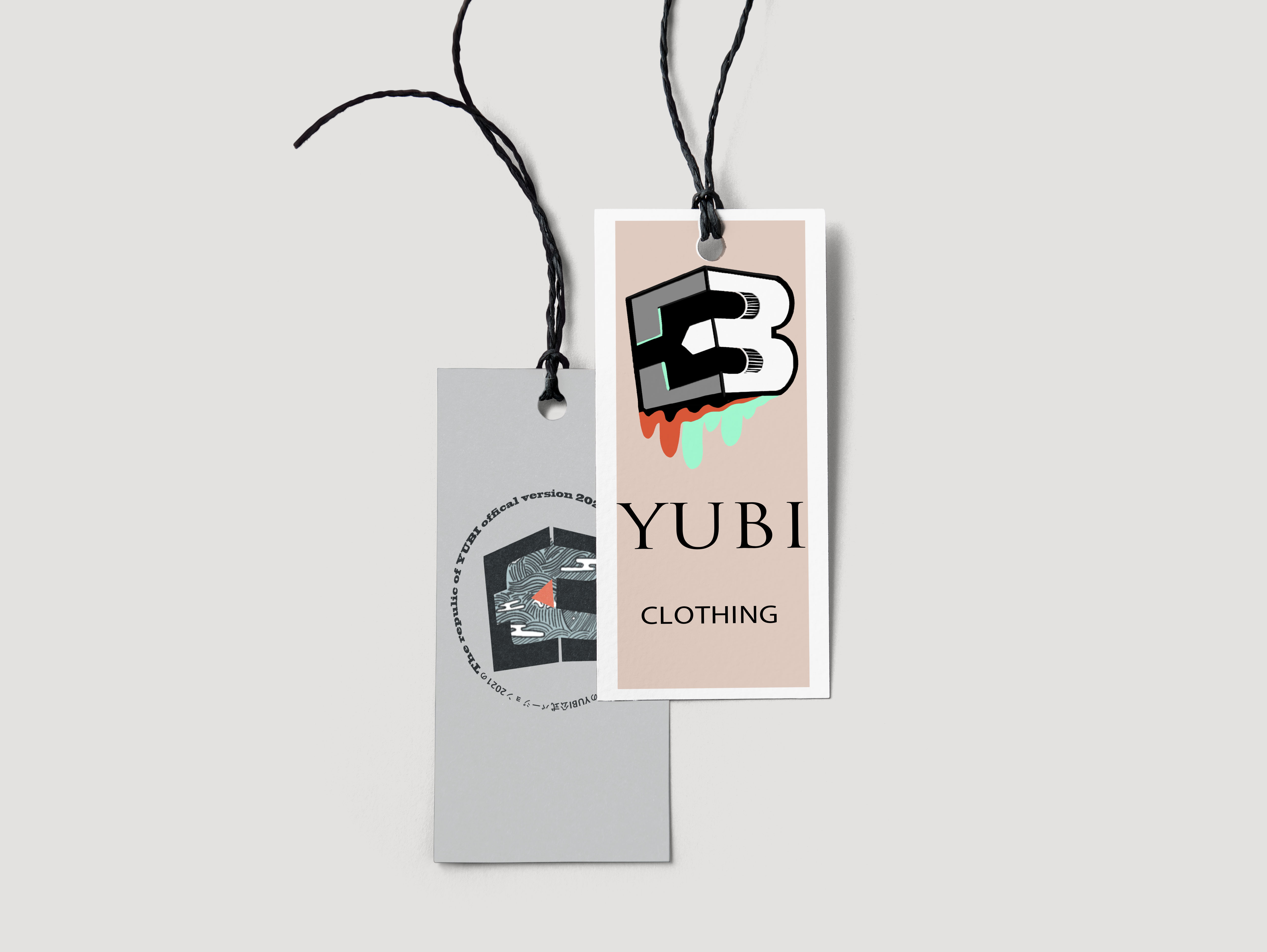 Clothing hang tags — branded labels with the YB cube logo